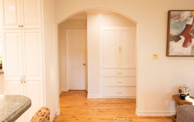 14816 Covello St, Van Nuys, CA 91405 - hall featuring arched walkways, light wood-type flooring, and baseboards