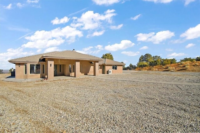 9050 Ponderosa Rd, Pinon Hills, CA 92372 - rear view of house featuring stucco siding, a patio, and a tile roof