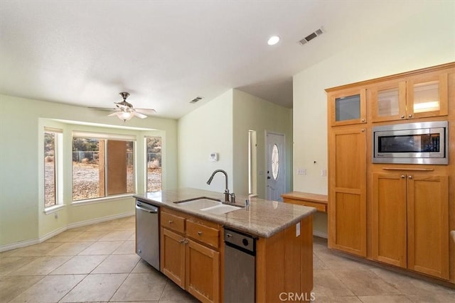 9050 Ponderosa Rd, Pinon Hills, CA 92372 - kitchen with stainless steel appliances, a sink, light tile patterned floors, a center island with sink, and light stone countertops