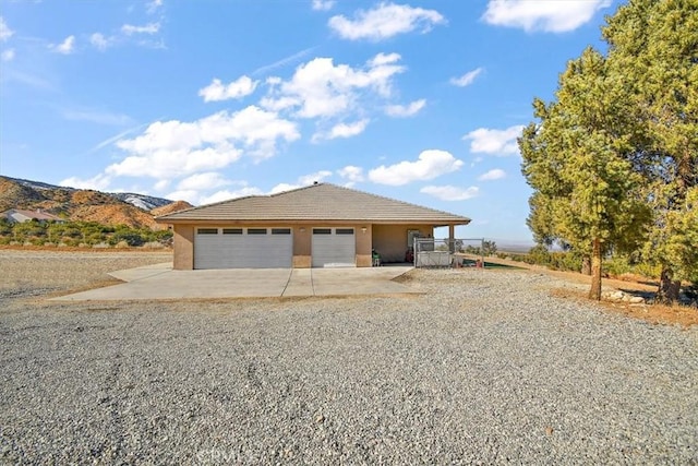 9050 Ponderosa Rd, Pinon Hills, CA 92372 - view of front of property featuring concrete driveway, stucco siding, an attached garage, and a tile roof