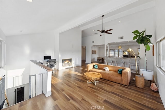 44310 Calle Bernardo, Temecula, CA 92590 - living room with a glass covered fireplace, lofted ceiling, wood finished floors, a ceiling fan, and recessed lighting