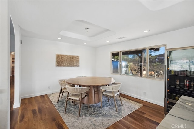44310 Calle Bernardo, Temecula, CA 92590 - dining space with recessed lighting, a skylight, baseboards, dark wood-style flooring, and a tray ceiling
