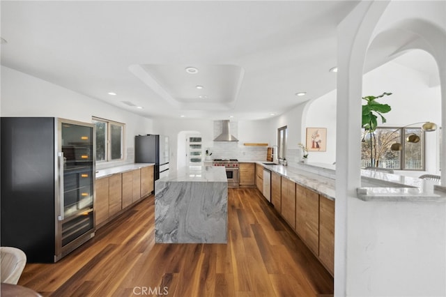 44310 Calle Bernardo, Temecula, CA 92590 - kitchen featuring wall chimney exhaust hood, modern cabinets, high quality appliances, brown cabinets, and recessed lighting