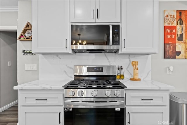 1422 S Exmoor Ave, Compton, CA 90220 - kitchen with stainless steel appliances, backsplash, white cabinetry, and light stone countertops