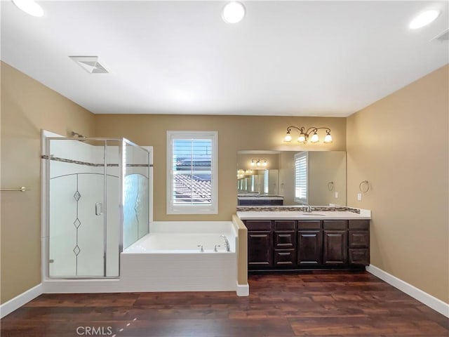 25329 Wild View Rd, Menifee, CA 92584 - bathroom featuring a garden tub, double vanity, wood finished floors, a shower stall, and baseboards