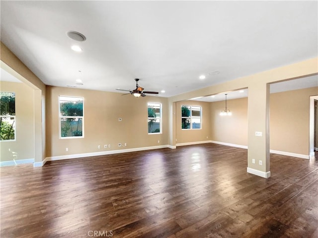 25329 Wild View Rd, Menifee, CA 92584 - unfurnished living room featuring healthy amount of natural light, dark wood-style flooring, a ceiling fan, baseboards, and recessed lighting