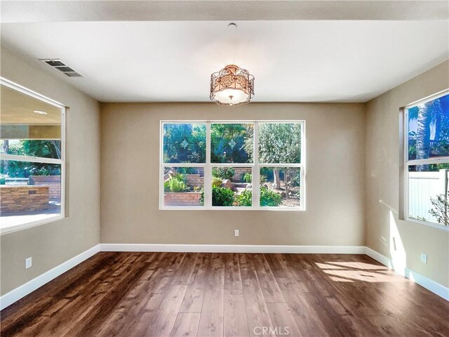 25329 Wild View Rd, Menifee, CA 92584 - empty room featuring wood finished floors, healthy amount of natural light, and baseboards