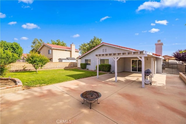 1819 Acosta Ave, Lancaster, CA 93535 - rear view of house with a fire pit, stucco siding, a patio, and a chimney