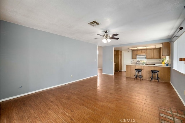 1819 Acosta Ave, Lancaster, CA 93535 - unfurnished living room featuring baseboards, ceiling fan, and wood finished floors