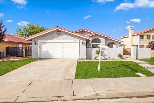 1819 Acosta Ave, Lancaster, CA 93535 - view of front of property with a tiled roof, stucco siding, a gate, an attached garage, and concrete driveway