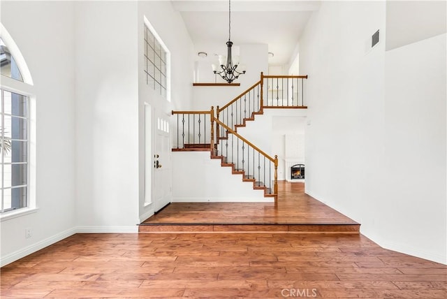 32911 Danaoak, Dana Point, CA 92629 - entrance foyer with a chandelier, a high ceiling, hardwood / wood-style floors, stairway, and a lit fireplace