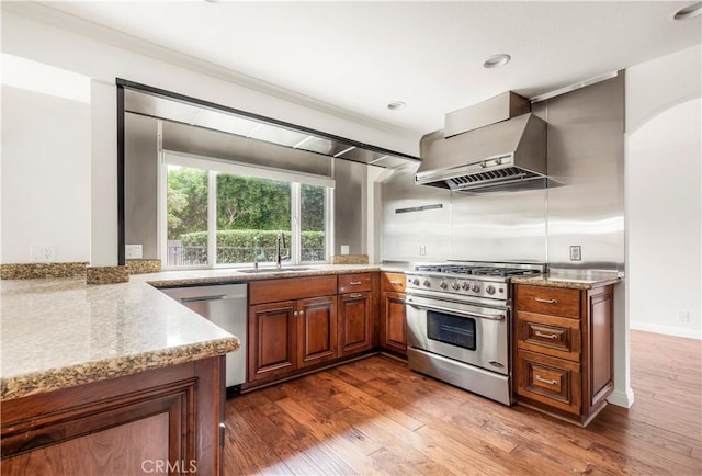 32911 Danaoak, Dana Point, CA 92629 - kitchen featuring appliances with stainless steel finishes, wall chimney exhaust hood, a sink, brown cabinets, and light stone countertops