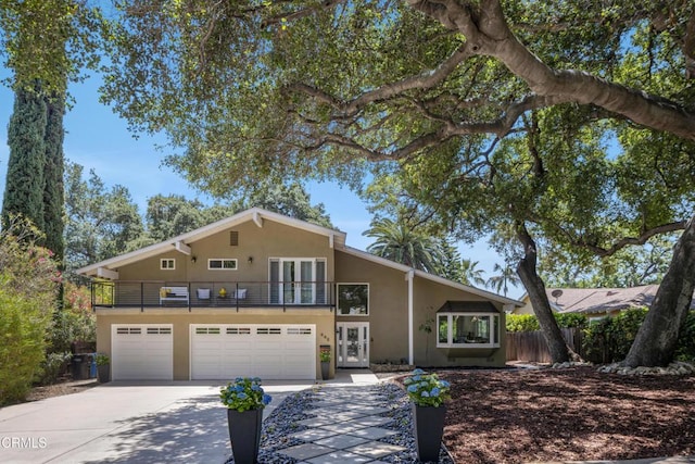 448 W Montecito Ave, Sierra Madre, CA 91024 - view of front of home featuring french doors, a balcony, stucco siding, driveway, and an attached garage