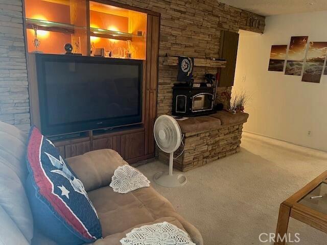 38833 Sage Tree St, Palmdale, CA 93551 - carpeted living area with a wood stove