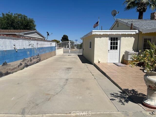 38833 Sage Tree St, Palmdale, CA 93551 - view of property exterior with a gate and stucco siding