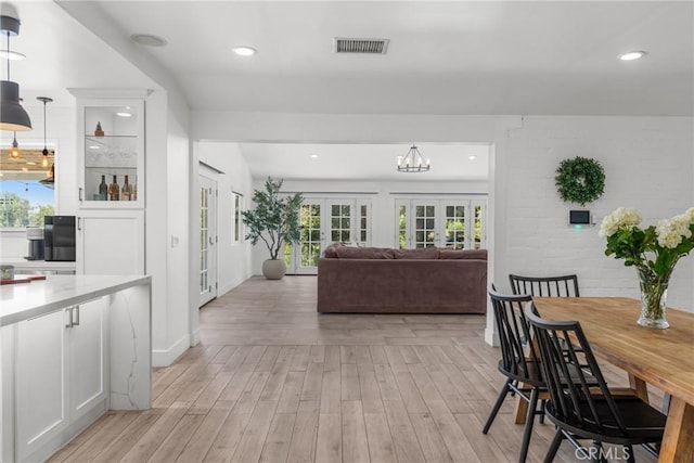 4674 Norton Pl, Riverside, CA 92506 - dining space with french doors, light wood-style floors, plenty of natural light, recessed lighting, and baseboards