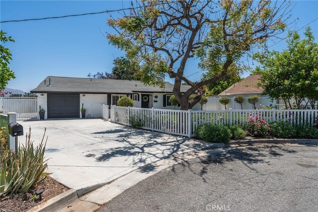 4674 Norton Pl, Riverside, CA 92506 - ranch-style house with an attached garage, driveway, and a fenced front yard