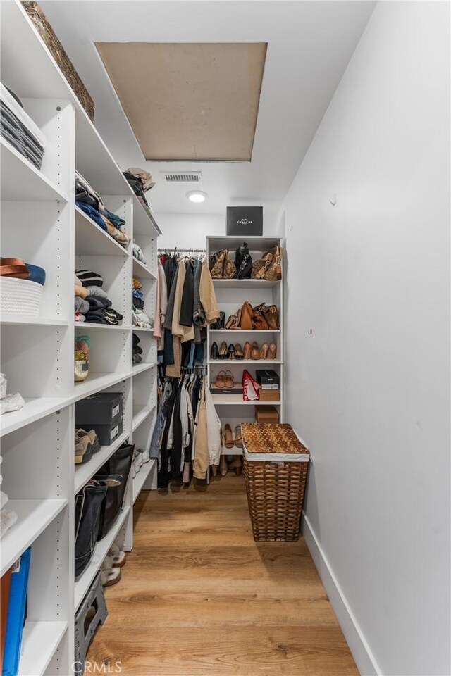4674 Norton Pl, Riverside, CA 92506 - walk in closet featuring light wood finished floors and attic access
