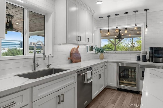 4674 Norton Pl, Riverside, CA 92506 - kitchen with beverage cooler, stainless steel dishwasher, a sink, backsplash, and wood finished floors