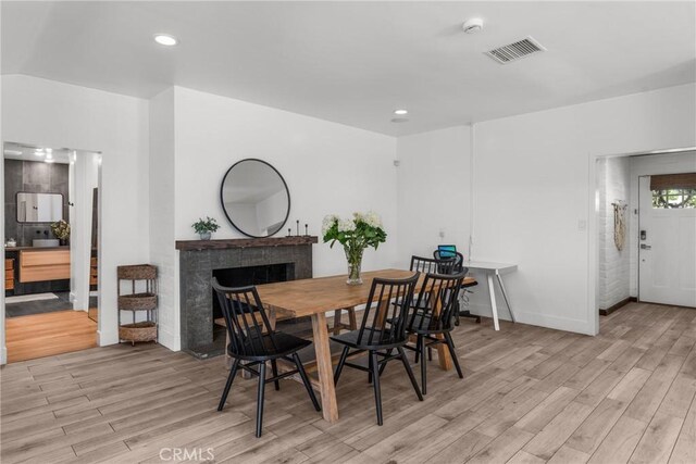 4674 Norton Pl, Riverside, CA 92506 - dining area featuring light wood-type flooring, a fireplace, baseboards, and recessed lighting