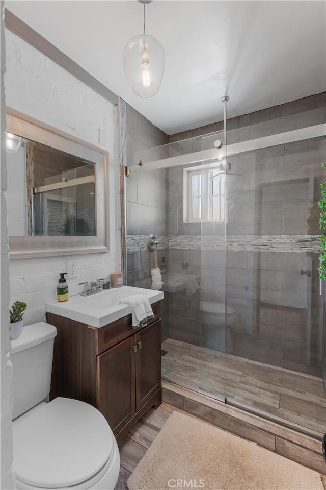 4674 Norton Pl, Riverside, CA 92506 - bathroom with toilet, vanity, a shower stall, and wood finished floors
