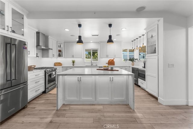 4674 Norton Pl, Riverside, CA 92506 - kitchen with high quality appliances, wall chimney exhaust hood, light countertops, recessed lighting, and a center island