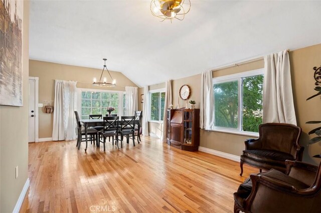 967 W 2nd Ave, Escondido, CA 92025 - dining room with a chandelier, vaulted ceiling, light wood-style flooring, and baseboards