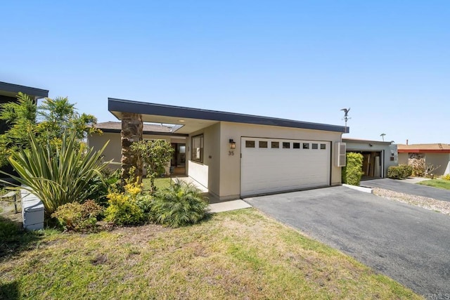 3890 Vista Campana S Unit 35, Oceanside, CA 92057 - mid-century home with an attached garage, driveway, and stucco siding