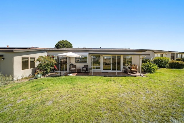 3890 Vista Campana S Unit 35, Oceanside, CA 92057 - back of property with roof mounted solar panels, a patio, a lawn, and stucco siding