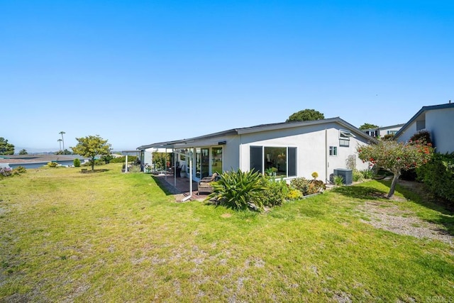 3890 Vista Campana S Unit 35, Oceanside, CA 92057 - back of house featuring a lawn, cooling unit, stucco siding, and a patio area