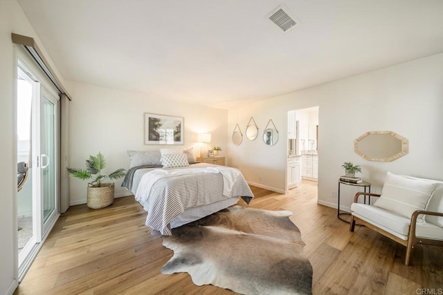 3890 Vista Campana S Unit 35, Oceanside, CA 92057 - bedroom featuring light wood-style flooring, baseboards, and connected bathroom