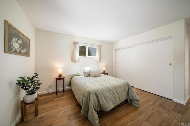 3890 Vista Campana S Unit 35, Oceanside, CA 92057 - bedroom with hardwood / wood-style flooring, baseboards, and a closet