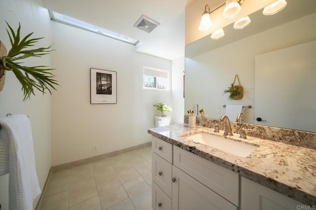 3890 Vista Campana S Unit 35, Oceanside, CA 92057 - bathroom featuring vanity, a skylight, tile patterned flooring, and baseboards