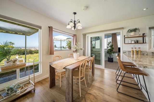3890 Vista Campana S Unit 35, Oceanside, CA 92057 - dining area featuring a chandelier, wood finished floors, and baseboards