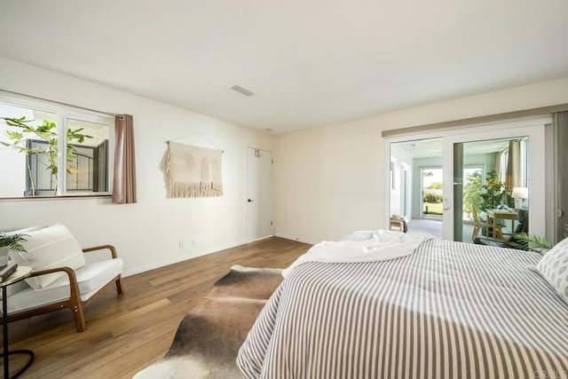 3890 Vista Campana S Unit 35, Oceanside, CA 92057 - bedroom featuring wood finished floors, baseboards, and access to exterior