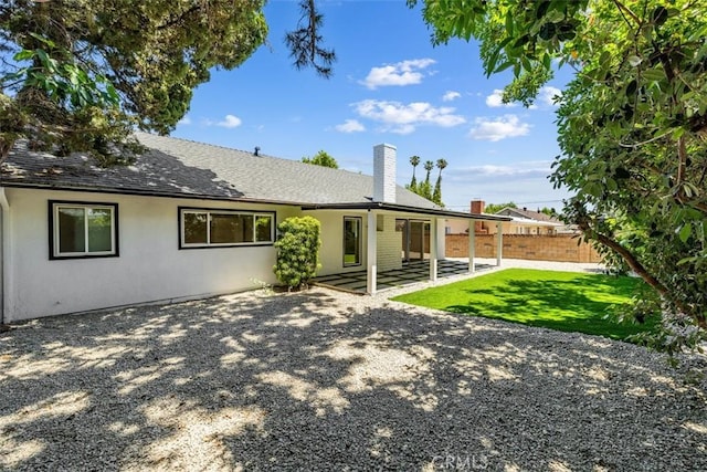 22306 Marlin Pl, Canoga Park, CA 91303 - back of house with a chimney, a patio area, roof with shingles, and stucco siding