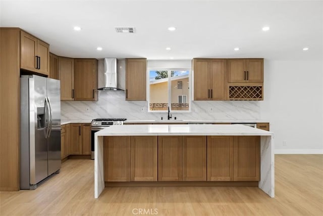 22306 Marlin Pl, Canoga Park, CA 91303 - kitchen with appliances with stainless steel finishes, wall chimney range hood, a center island, light wood finished floors, and recessed lighting