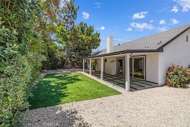 22306 Marlin Pl, Canoga Park, CA 91303 - rear view of property with a chimney, a patio, a lawn, stucco siding, and a shingled roof