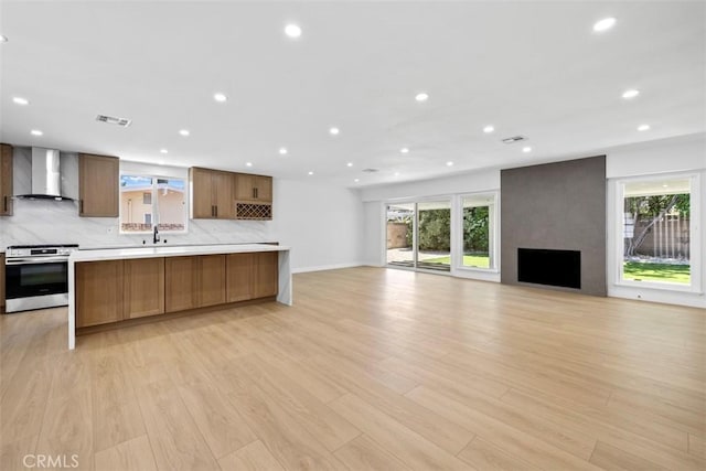 22306 Marlin Pl, Canoga Park, CA 91303 - kitchen featuring stainless steel range with electric cooktop, wall chimney range hood, healthy amount of natural light, open floor plan, and recessed lighting