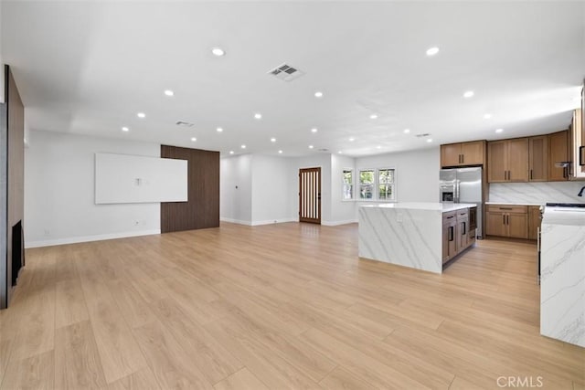 22306 Marlin Pl, Canoga Park, CA 91303 - kitchen featuring stainless steel refrigerator with ice dispenser, a center island, recessed lighting, light stone counters, and open floor plan