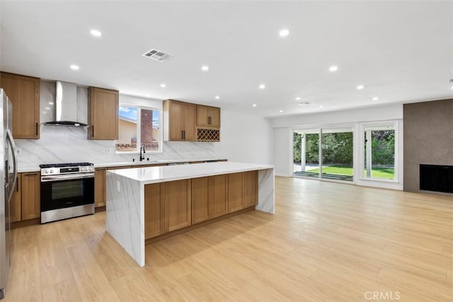 22306 Marlin Pl, Canoga Park, CA 91303 - kitchen featuring wall chimney range hood, stainless steel appliances, open floor plan, a large island, and backsplash