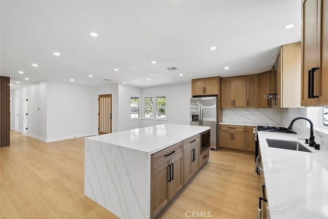 22306 Marlin Pl, Canoga Park, CA 91303 - kitchen featuring stainless steel appliances, a kitchen island, a sink, recessed lighting, and light wood-style flooring