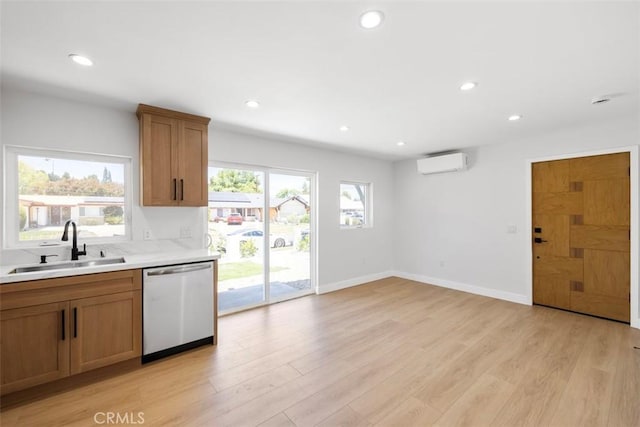 22306 Marlin Pl, Canoga Park, CA 91303 - kitchen with stainless steel dishwasher, a wall mounted AC, light countertops, light wood-style floors, and a sink