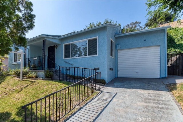 2107 Cyril Ave, Los Angeles, CA 90032 - view of front of home featuring concrete driveway, stucco siding, and a garage