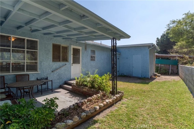 2107 Cyril Ave, Los Angeles, CA 90032 - rear view of house with stucco siding and a patio area