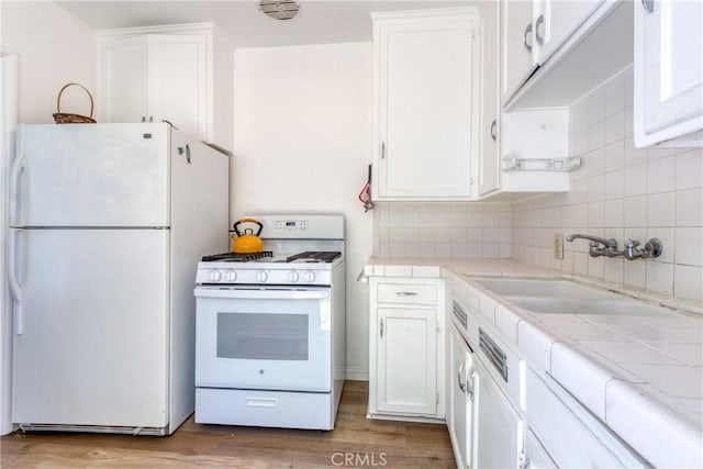 2107 Cyril Ave, Los Angeles, CA 90032 - kitchen with white appliances, tile counters, and white cabinets