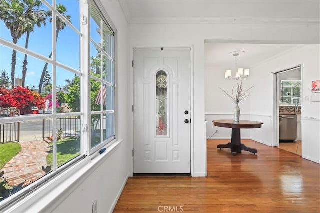 11900 Covello St, North Hollywood, CA 91605 - entrance foyer featuring ornamental molding, a chandelier, healthy amount of natural light, wood finished floors, and baseboards