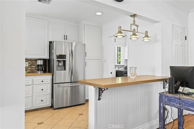 11900 Covello St, North Hollywood, CA 91605 - kitchen featuring stainless steel fridge with ice dispenser, white cabinets, ornamental molding, decorative backsplash, and a breakfast bar