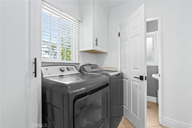 11900 Covello St, North Hollywood, CA 91605 - laundry area with washer and clothes dryer, cabinet space, and light tile patterned flooring