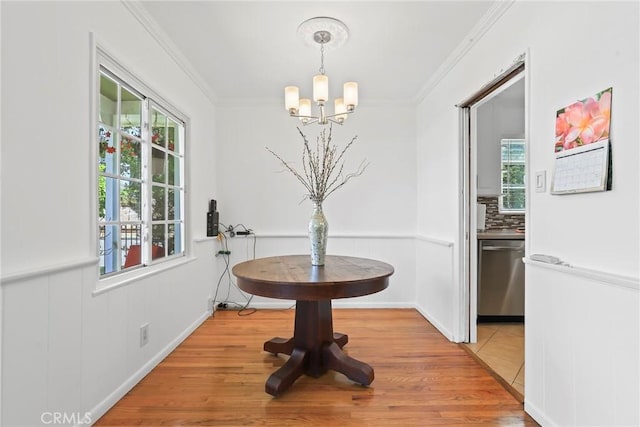 11900 Covello St, North Hollywood, CA 91605 - dining space with a chandelier, plenty of natural light, light wood-style flooring, and ornamental molding